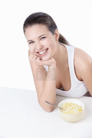 Young girl at breakfast on a white background