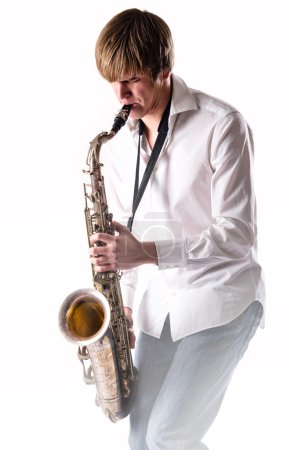 Young man with saxophone over white background