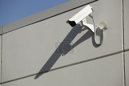 Security video camera mounted outdoors on a wall