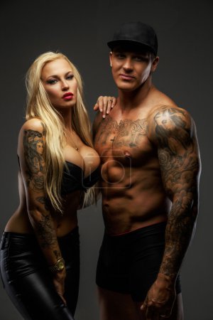 Blond female posing near muscular guy
