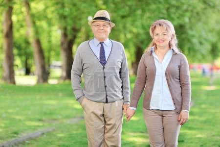 Mature couple holding hands in a park