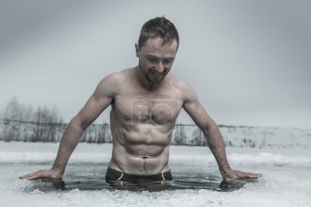 Man bathing in the ice hole