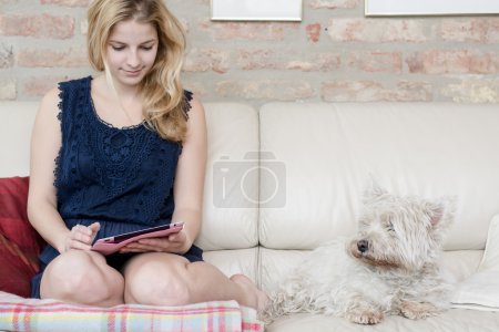 Home office, blonde girl using tablet