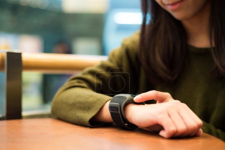 Woman touch on the screen of smart watch