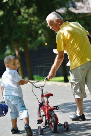 Happy grandfather and child in park