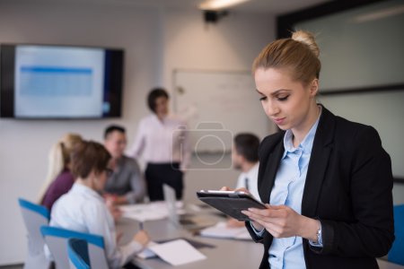 business woman working on tablet at meeting room