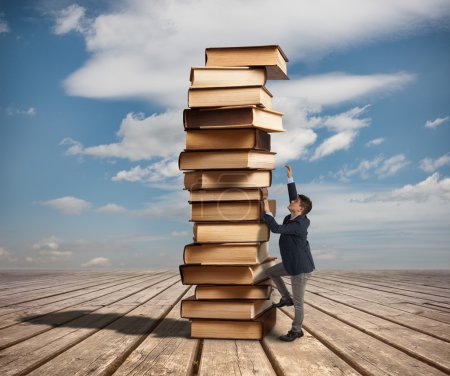 Man climbing a stack of books