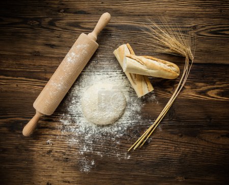 Yeast dough on table with rolling pin