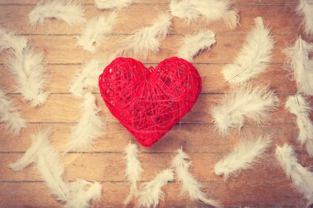 Toy heart shape and feathers