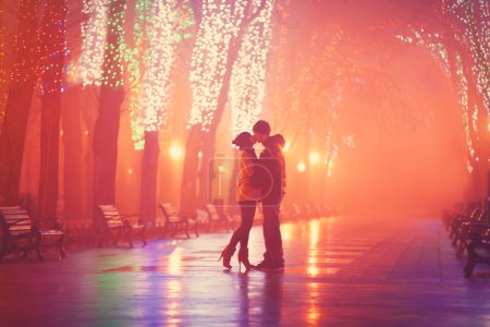 Couple kissing at night alley. 