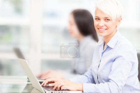 smiling employee portrait with blurred people background