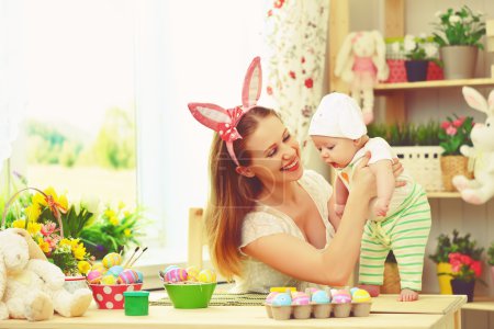 happy family celebrating easter mother and baby with bunny ears 