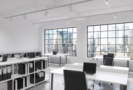 Workplaces in a bright modern loft open space office. Tables equipped with laptops; corporate documents' shelves. New York in the panoramic windows. 3D rendering.