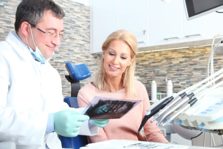 woman sitting at dentist and consulting