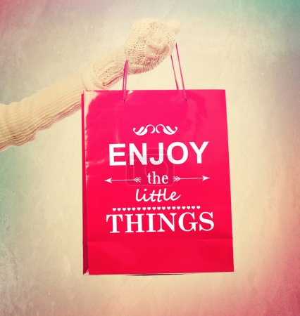 Woman holding shopping bag with inspirational quotation