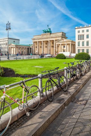 Berlin - Germany  - September 29 : People walks on Parisen Platz (Paris Square)  next to Brandenburg Gate in Berlin, Germany. Bicycles are locked to the steel fence around the square.