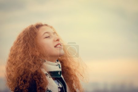 Happy,smiling little girl  enjoying a new breath of fresh air freedom