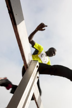 african american athlete jumping during obstacle race