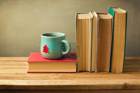 Books and tea cup on table