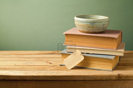 Books and bowl on table