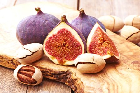 Fresh figs and nuts on wooden table
