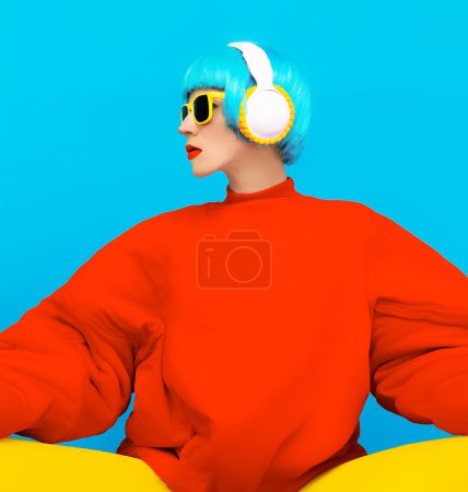 Glamorous fashion lady in bright clothes listening to music. All