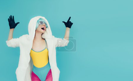 Positive girl on bright blue background. winter Style