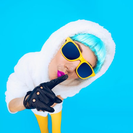 Positive girl on bright blue background. winter Style