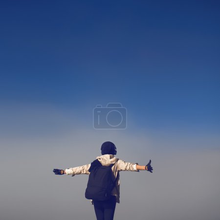 Lifestyle photo. girl tourist in thick fog greets morning hike.
