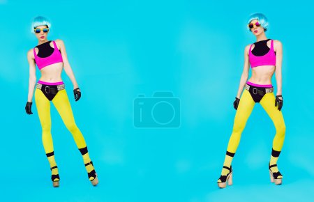 Glamorous fashion dj girl in bright clothes on a blue background