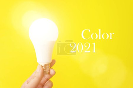 Pantone Color of the Year 2021. Bulb Light In Hand. Color trend. Illuminating