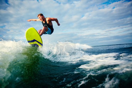 Male surfer riding on waves