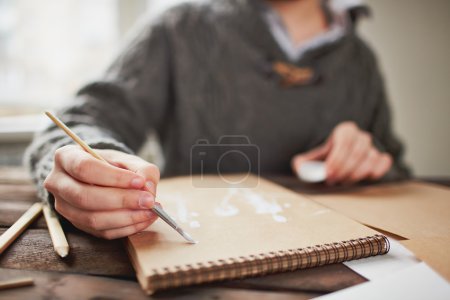 Young man drawing with brush