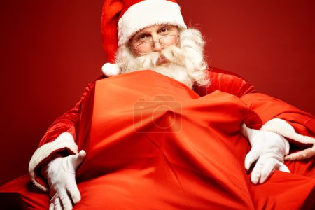Santa Claus embracing gigantic sack