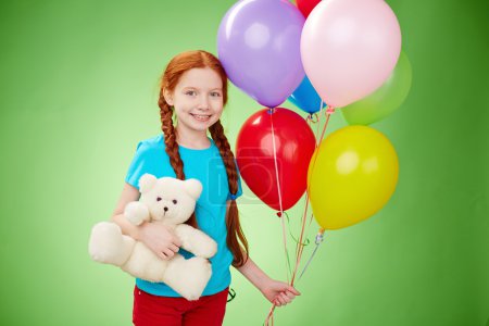 Girl with teddybear and balloons