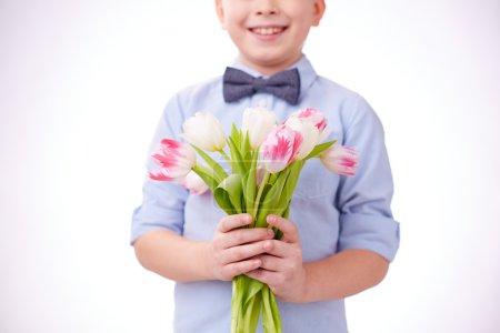 Boy holding bunch of tulips