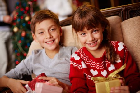 Girl and boy with Christmas gifts