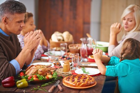 Family sitting at Thanksgiving festive table