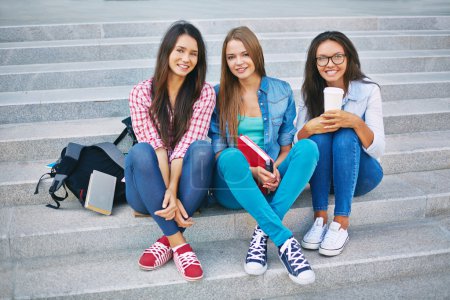 Teenage girls sitting on steps