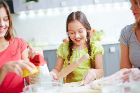 Little girl making dough