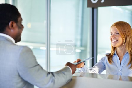 Woman giving ticket to businessman