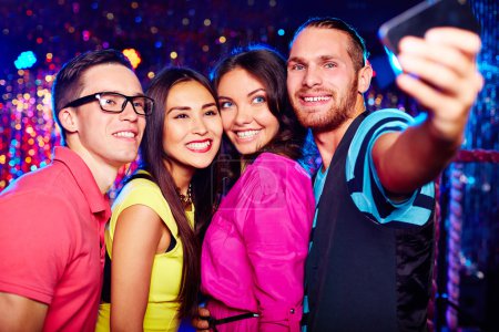 People taking selfie at party