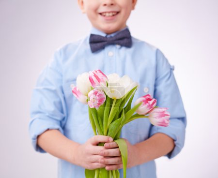Little boy holding tulips