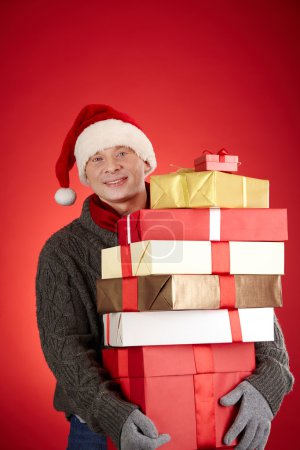 Santa man with pile of gift boxes