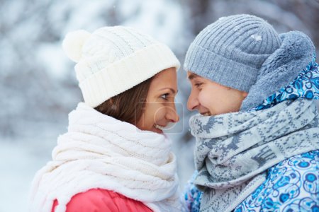 Happy young woman and man in winterwear
