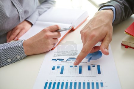 Male hand pointing at business document