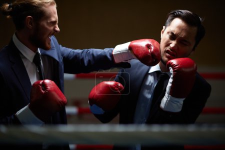 Businessman fighting with rival