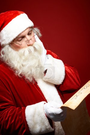 Santa Claus reading Christmas letter