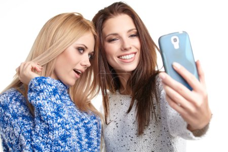 Girls making selfies at studio