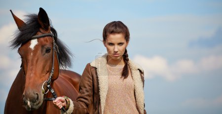 Girl and horse on the walk 